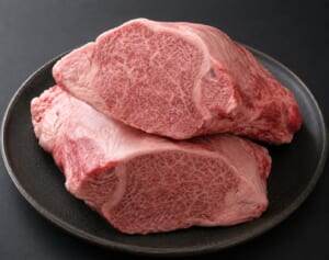 Thick-cut A5 heifer wagyu fillet with fine marbling on a dark plate