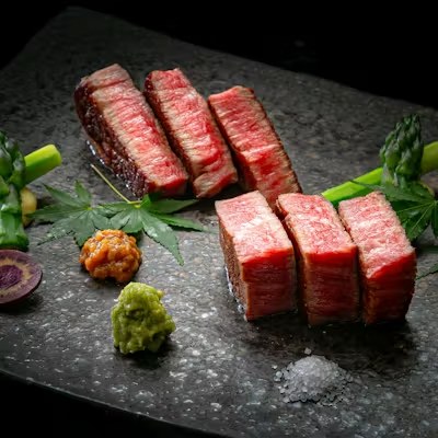 Thick-cut wagyu served on a stone plate for yakiniku at 芦屋焼肉 結 YUI, Ashiya